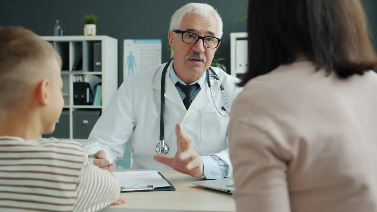 Oudere persoon in gesprek met een arts over kosten en terugbetaling van een geriatrische raadpleging