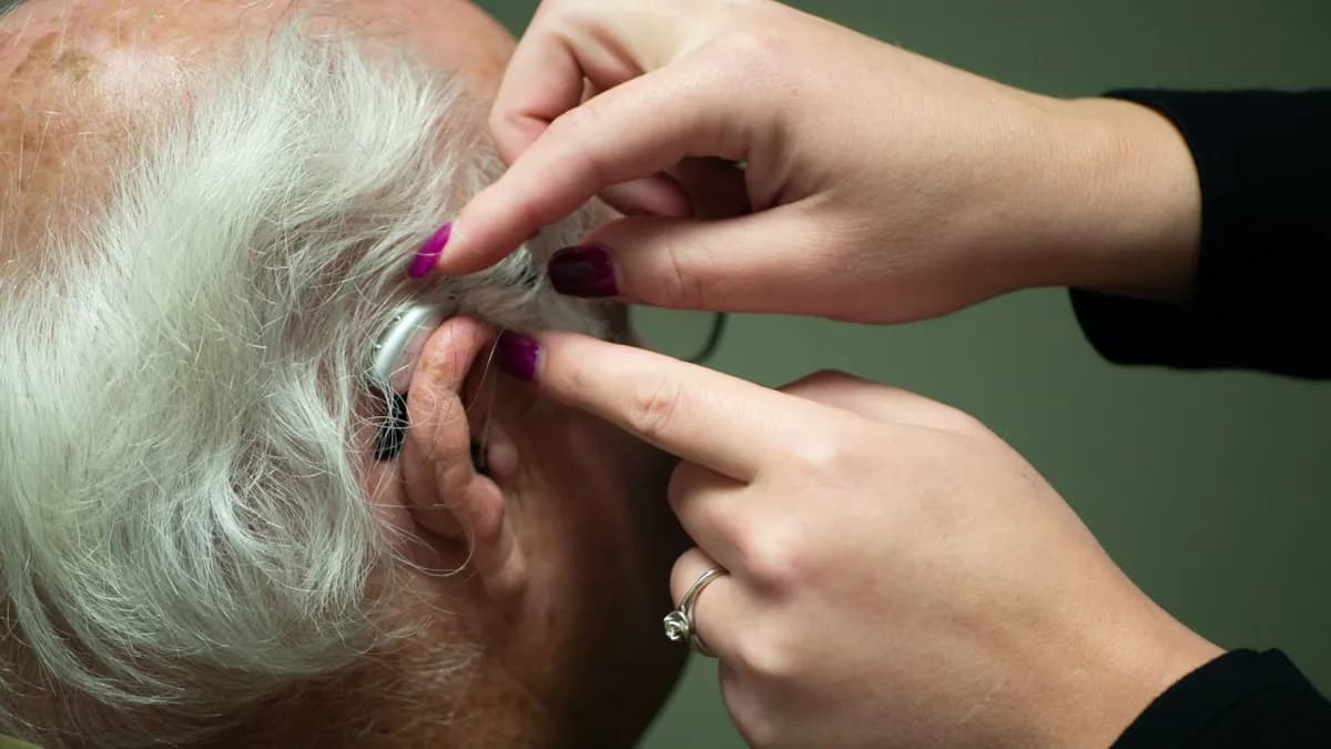Zorgverlener bespreekt gehoor en spraak met een volwassen patient